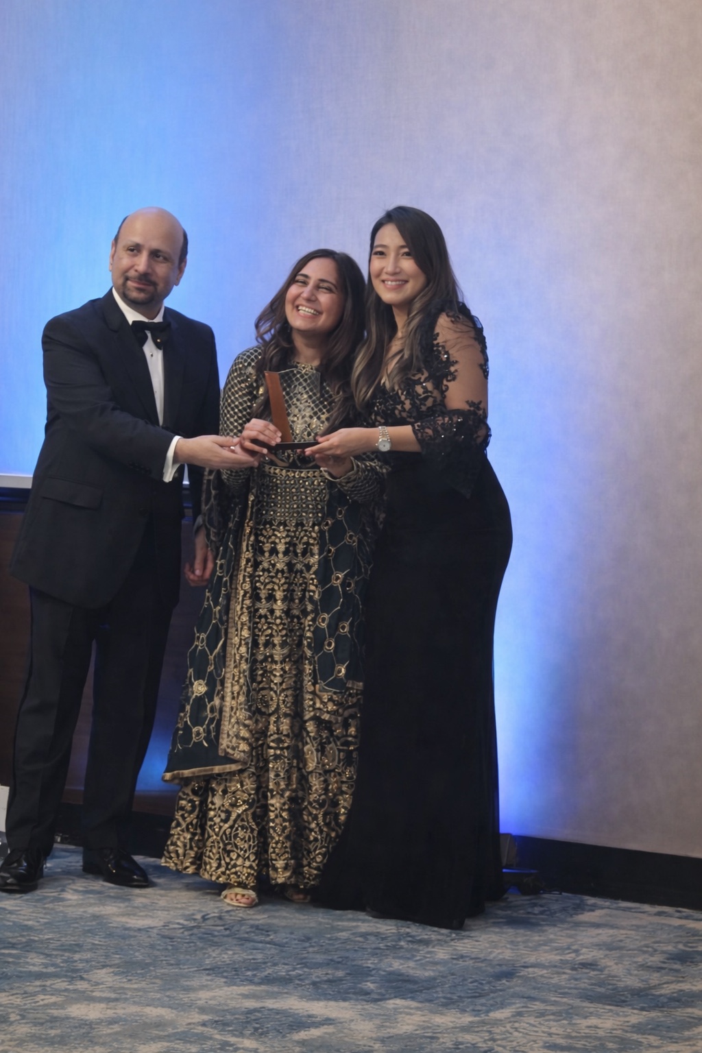 Melange team members celebrating at an industry event